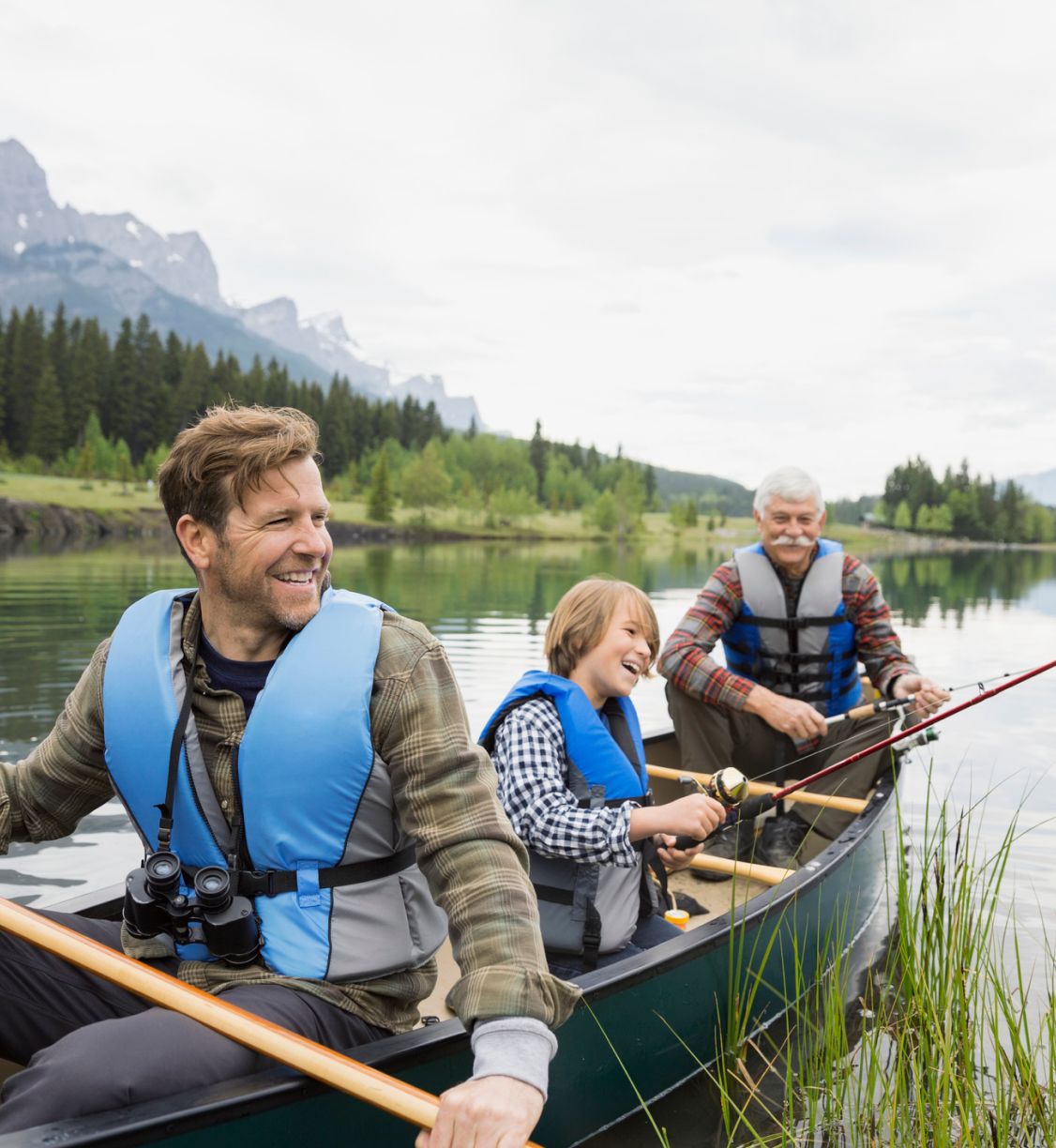 A father fishing with his dad and son.