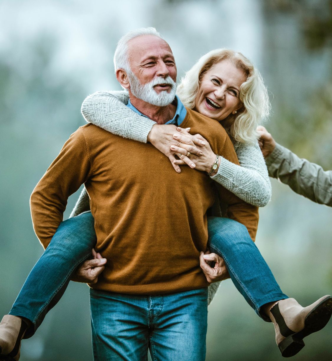 An older couple acting playful towards each other.